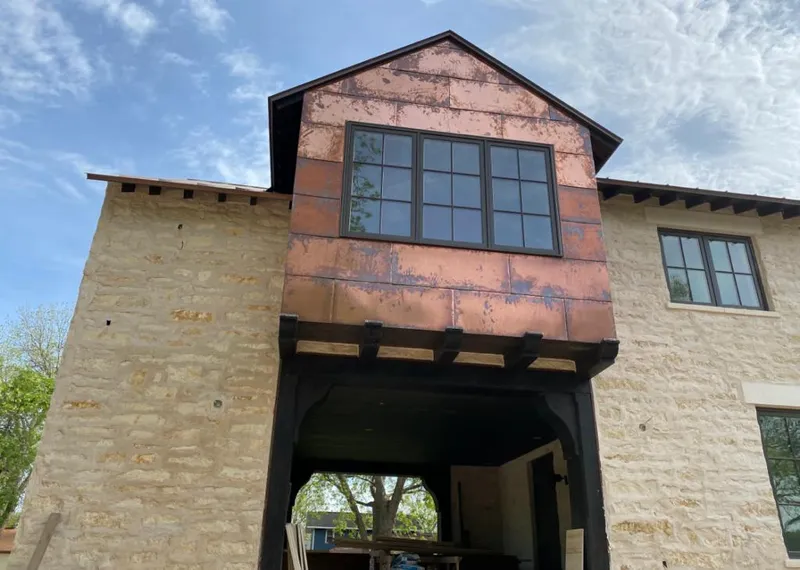 Copper metal panel facade on a stone building for Metal Roof Coating in Littlefield