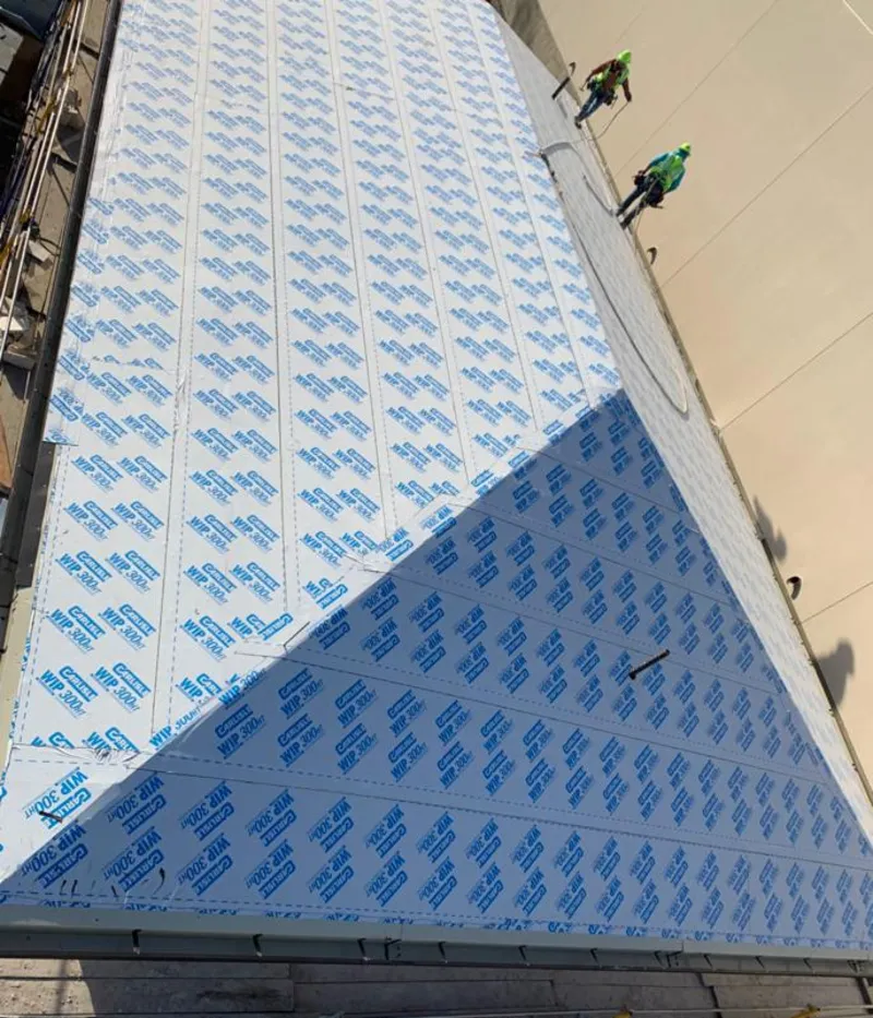 Professional roofers installing underlayment on a metal roof in Littlefield